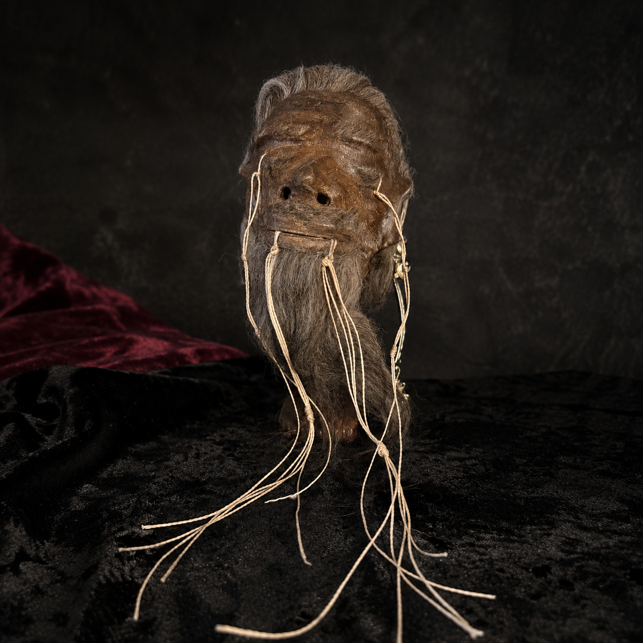 ash-gray-haired alpaca hide shrunken head replica front view
