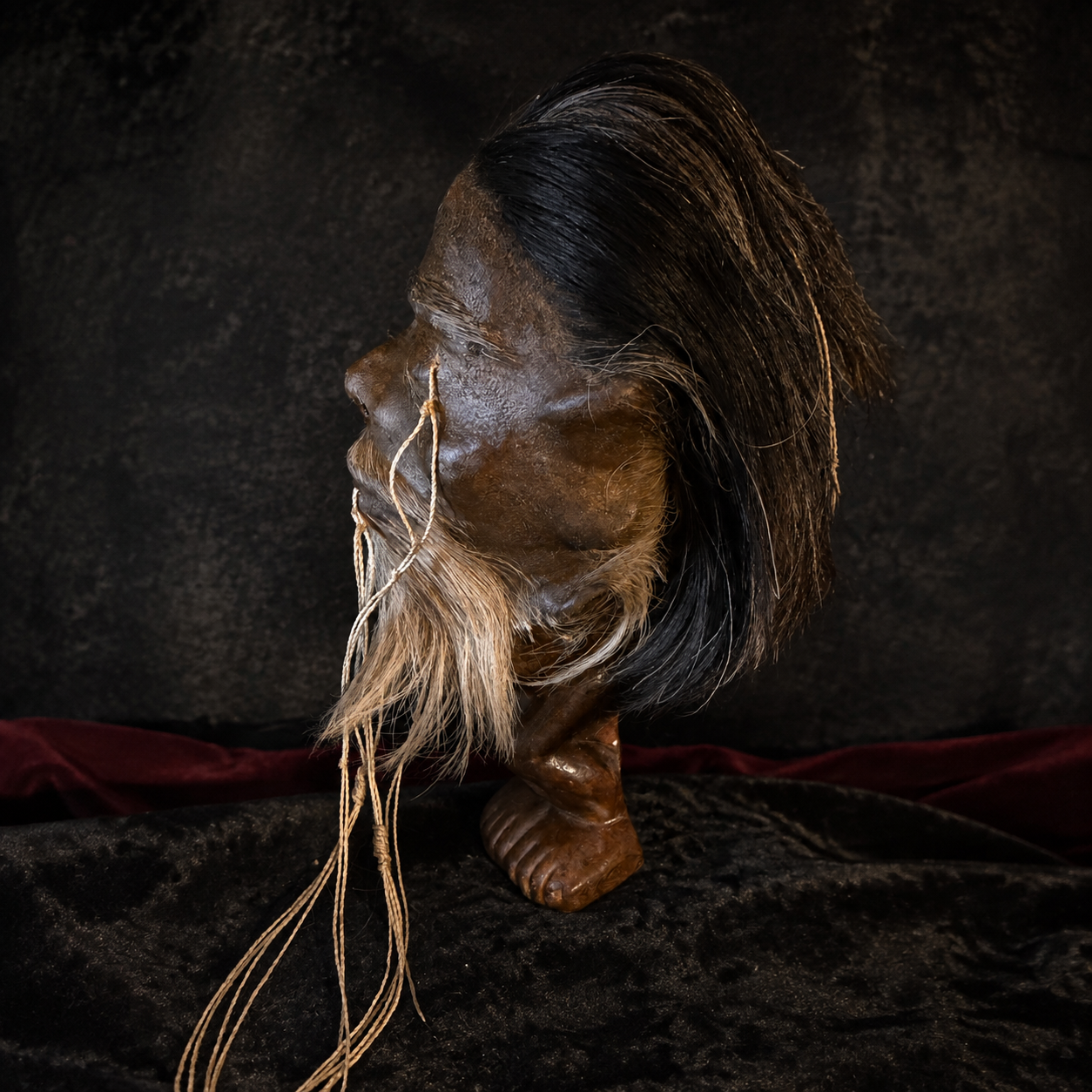 black-haired with white goatee alpaca hide shrunken head replica side profile