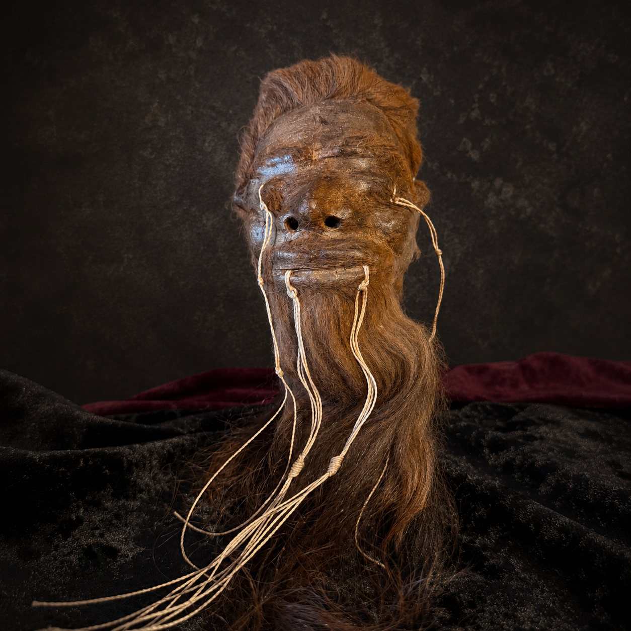 long auburn-haired alpaca hide shrunken head replica front view