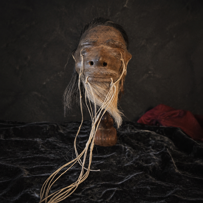 black-haired with white goatee alpaca hide shrunken head replica front view
