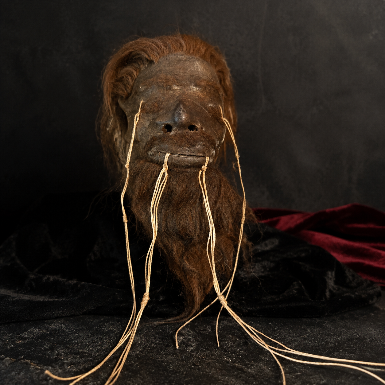 chestnut-haired and bearded alpaca hide shrunken head replica front view