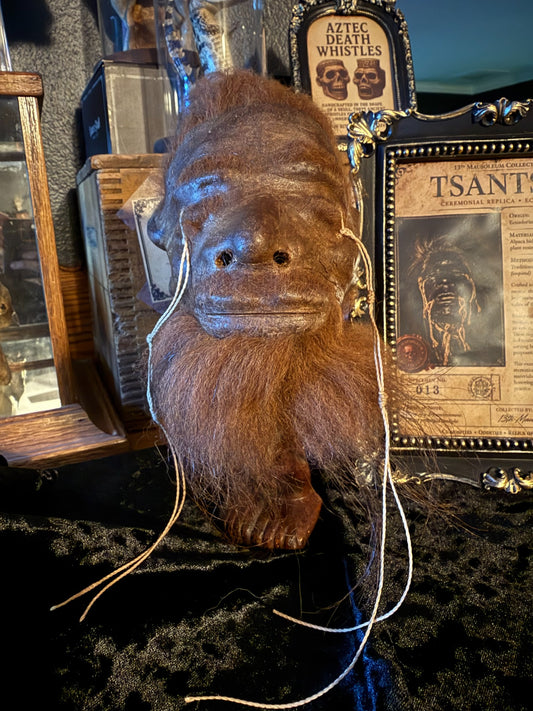 Brown alpaca hide shrunken head replica with cord stitching