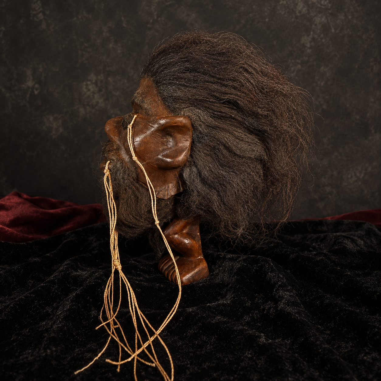 black-haired, dark-bearded alpaca hide shrunken head replica side profile